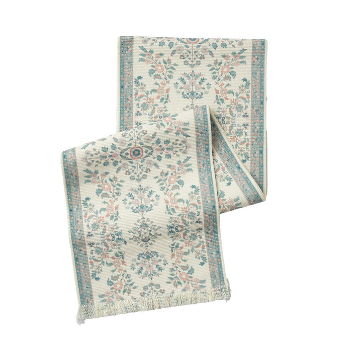 Vintage-inspired woven table runner with floral border and fringes