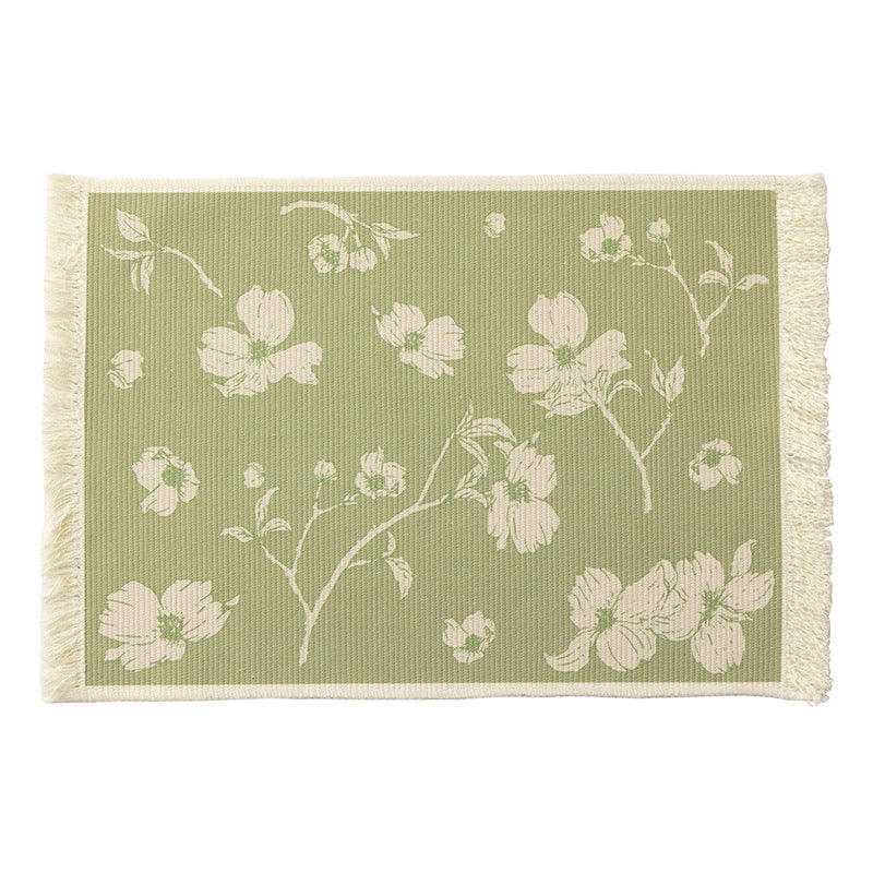 Floral woven bath mat with decorative fringes
