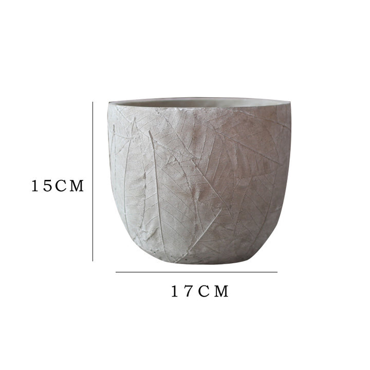 Decorative plant container made of handmade ceramic with leaf pattern