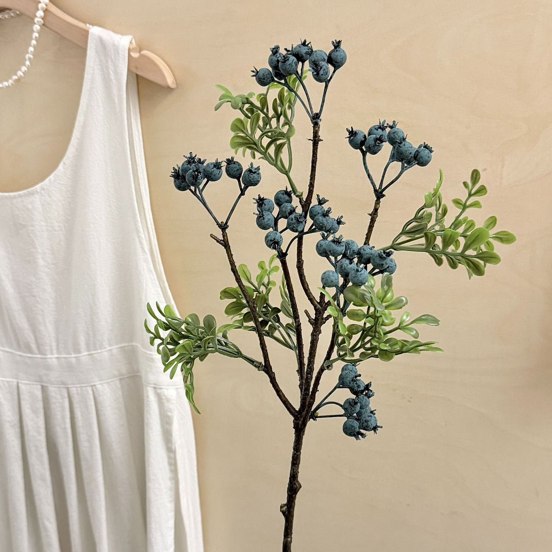Artificial branch with glowing berries and green
