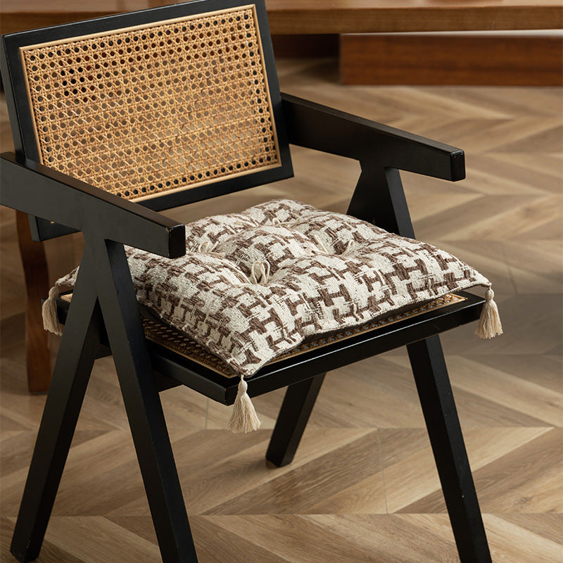 Decorative woven seat cushion with tufting and tassels