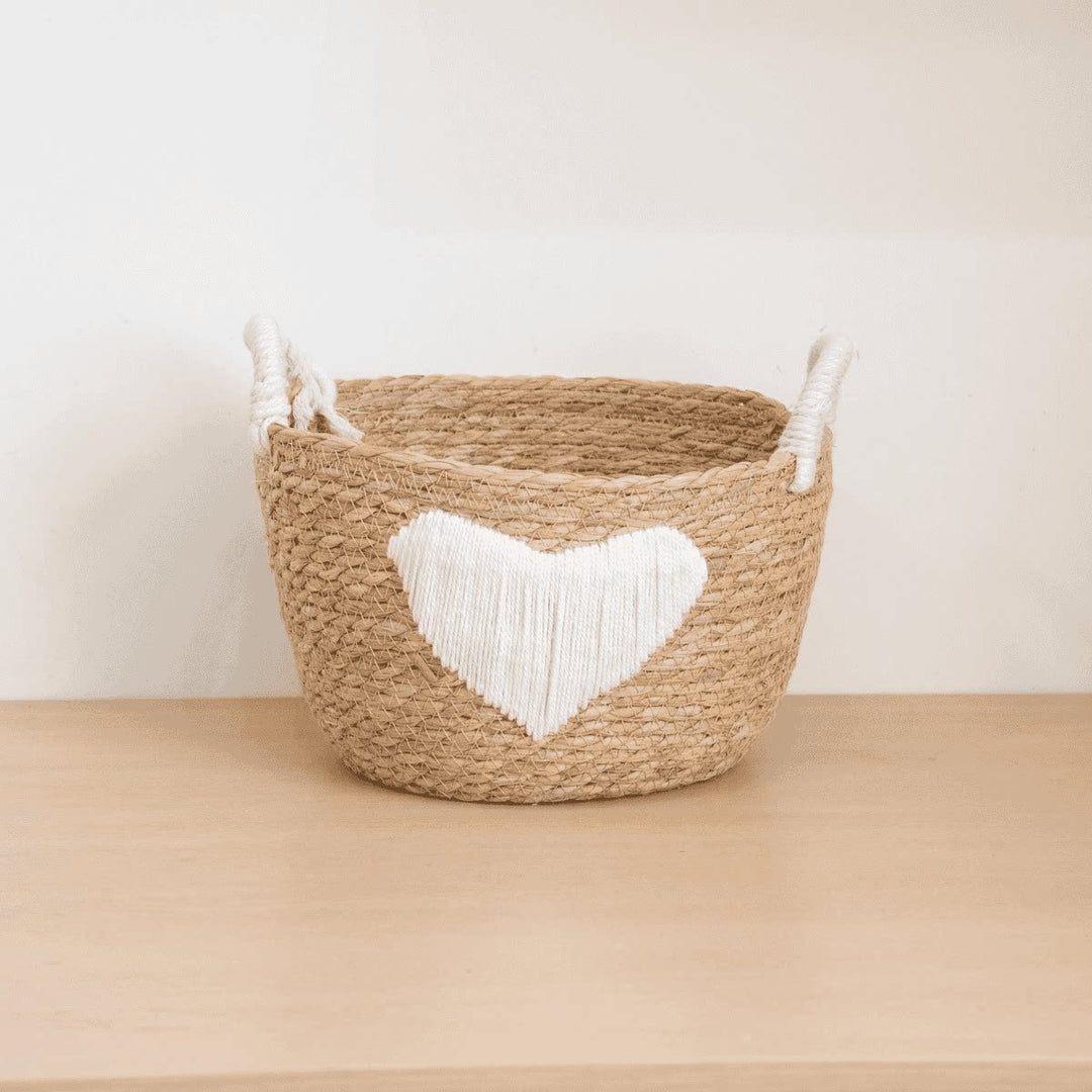 Handwoven storage basket with heart design