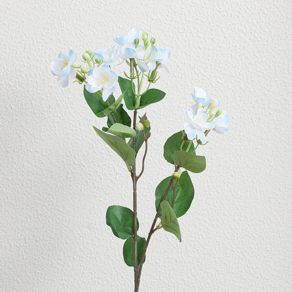 Artificial flower branch with vibrant pink flowers