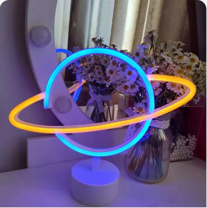 Saturn-inspired LED orb table lamp with dual-colored neon rings