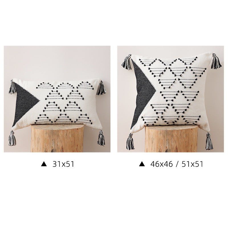 Decorative woven cushion cover with geometric tuft-relief and tassels