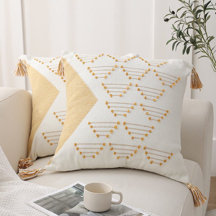 Decorative woven cushion cover with geometric tuft-relief and tassels