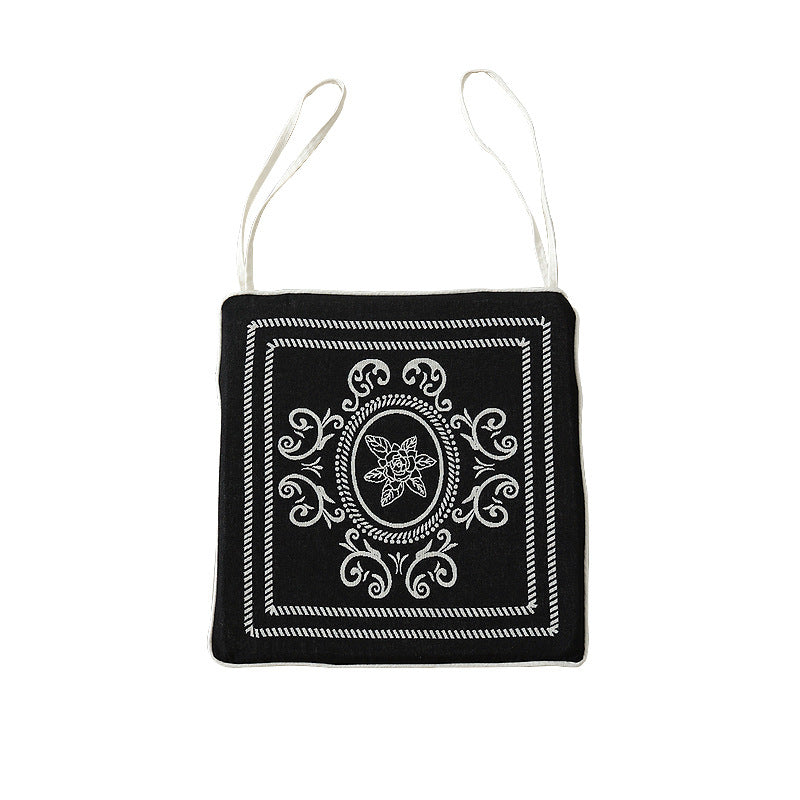 Double-sided seat cushion with ties and decorative jacquard pattern