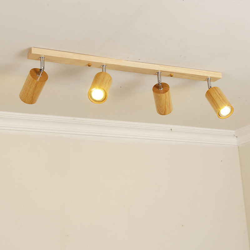 Wood beam ceiling rail with adjustable cylinder spotlights