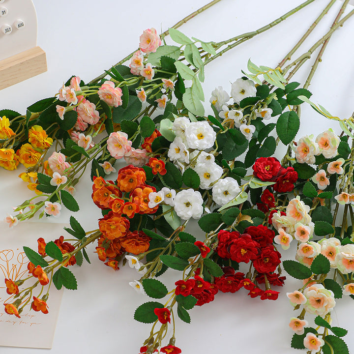 Artificial branch with decorative flowers
