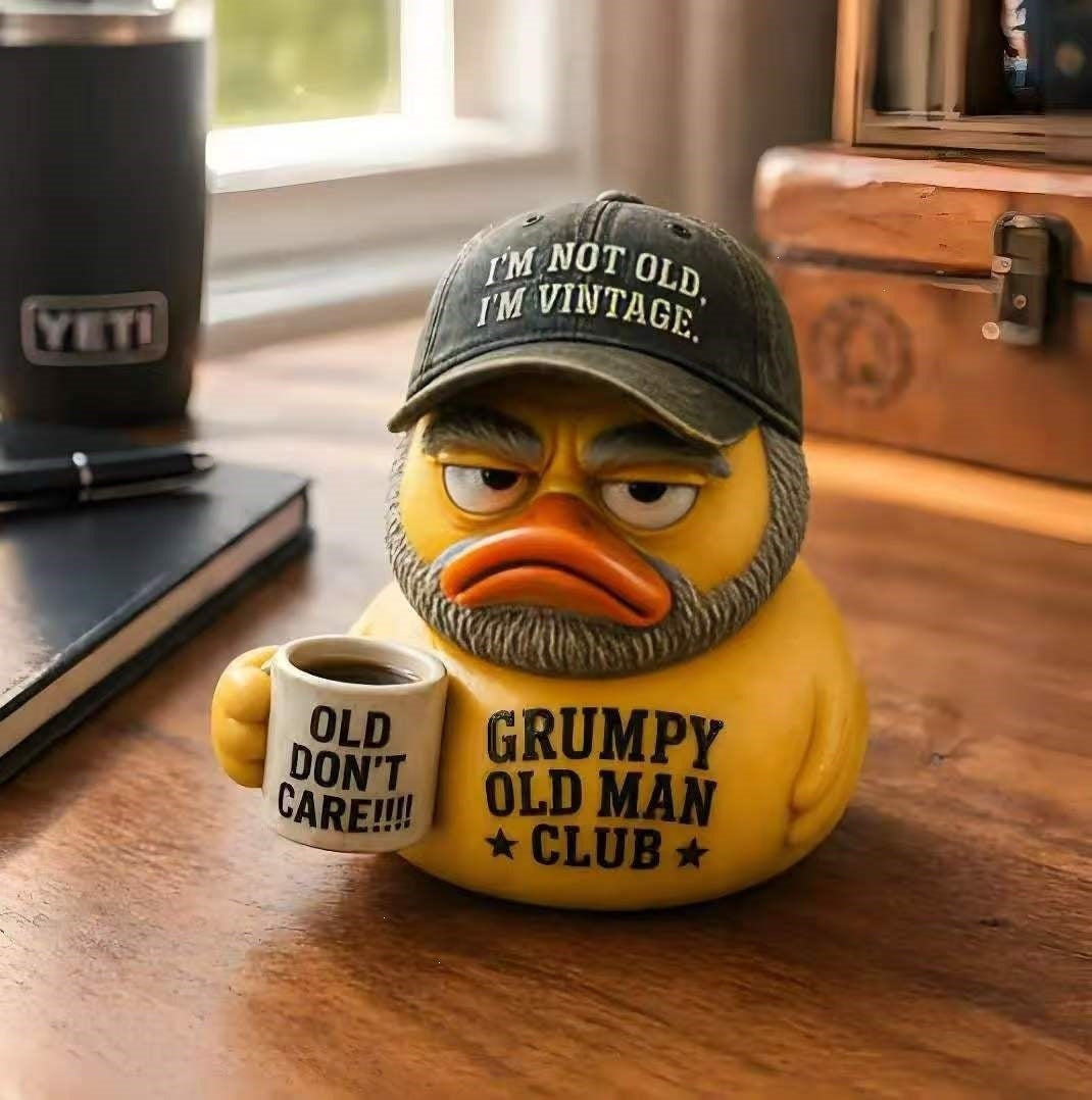 Funny rubber duck with vintage hat and cup