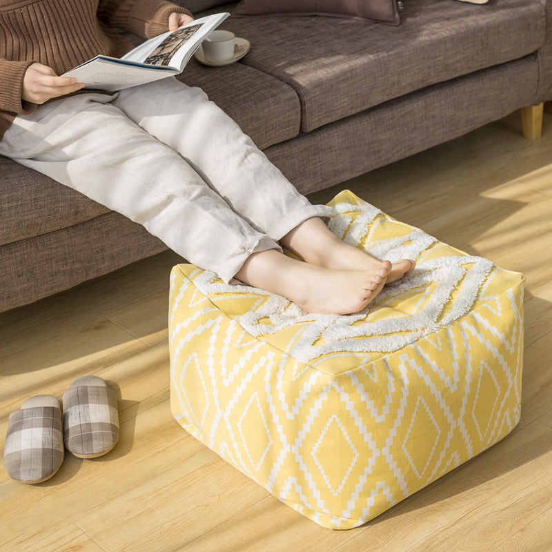 Padded footstool pouf with plush top and woven diamond pattern