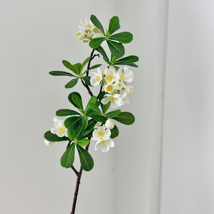 Artificial flower branch with fine pink flowers and vibrant leaves