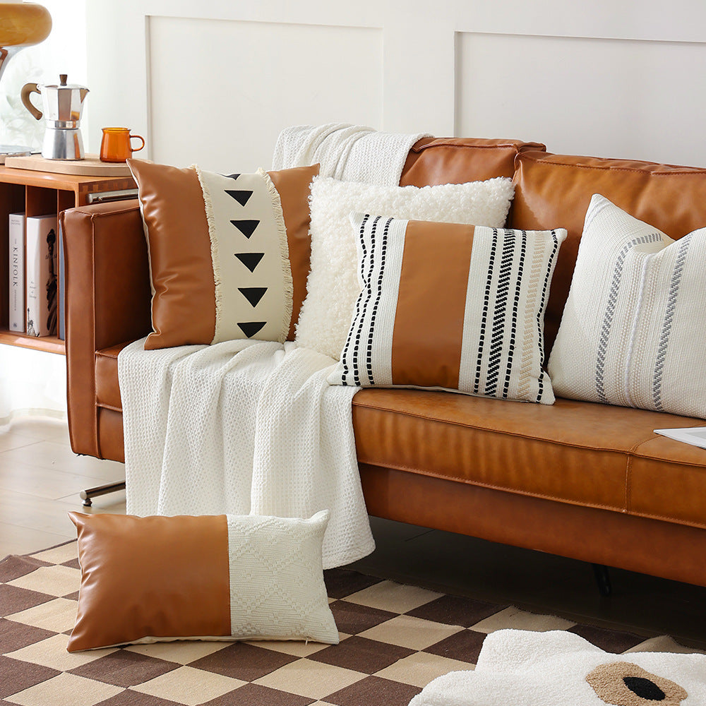 Decorative cushion cover made of faux leather with woven ethnic stripe
