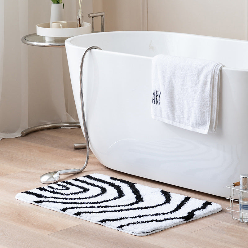 Fluffy bath mat in a graphic wave relief with anti-slip base