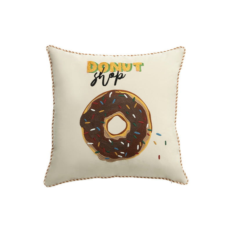 Square decorative pillow cover with hand-embroidered donut appliqué and piping