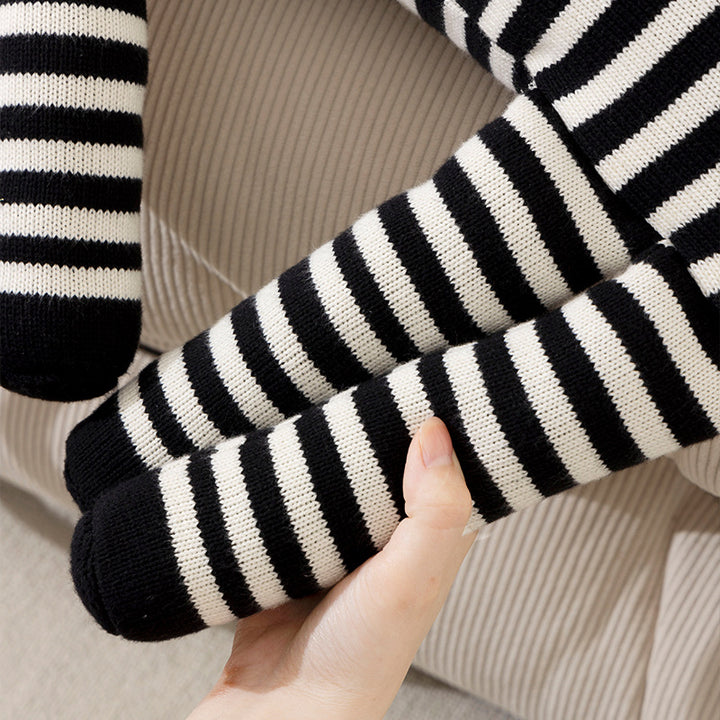 Striped decorative knitted cushion in animal shape with fringes and four-legged look