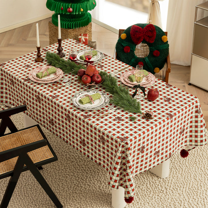 Rectangular decorative tablecloth with checkered pattern, pompom trim, and fine embroidered applique