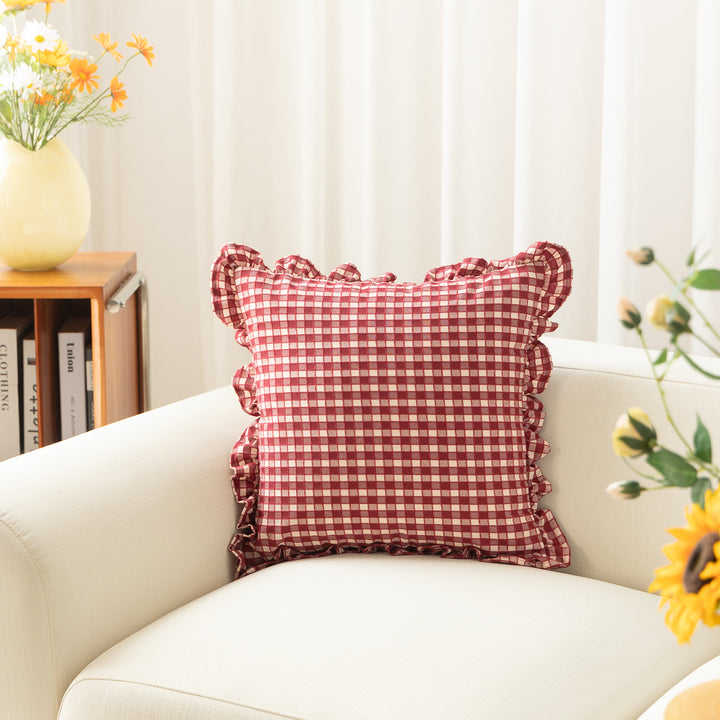 Decorative cushion with gingham pattern and playful ruffled edge