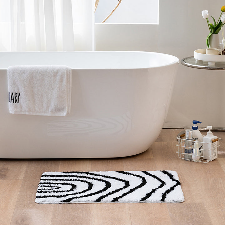 Fluffy bath mat in a graphic wave relief with anti-slip base