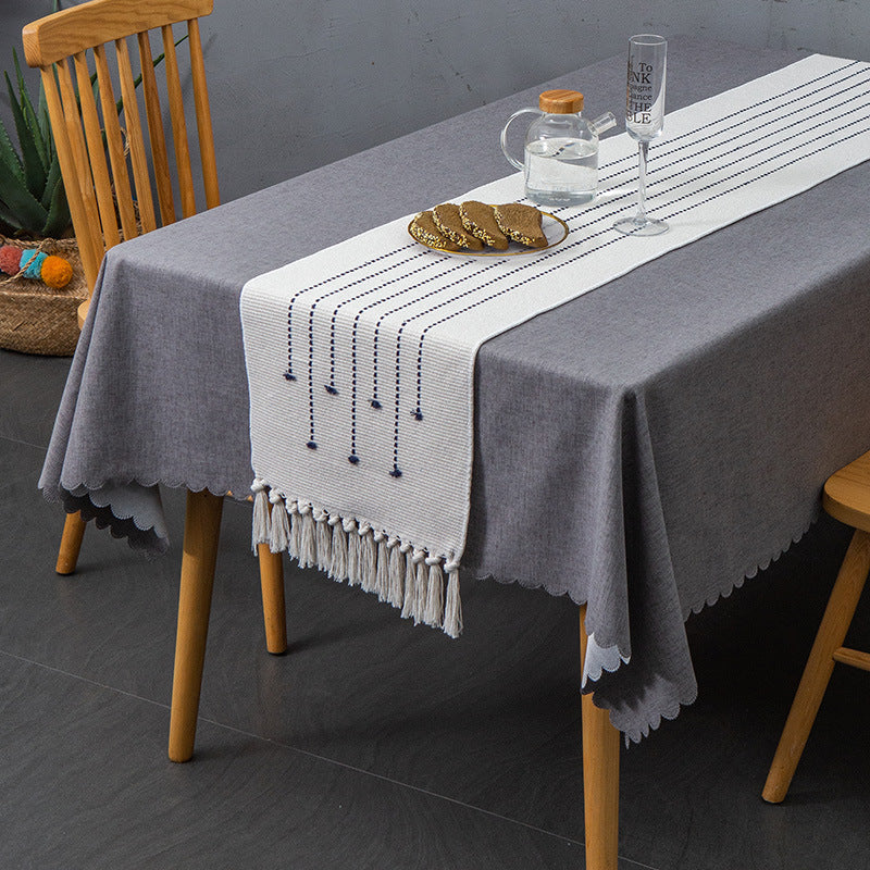 Decorative table runner in Scandinavian-minimalist design with macrame fringes
