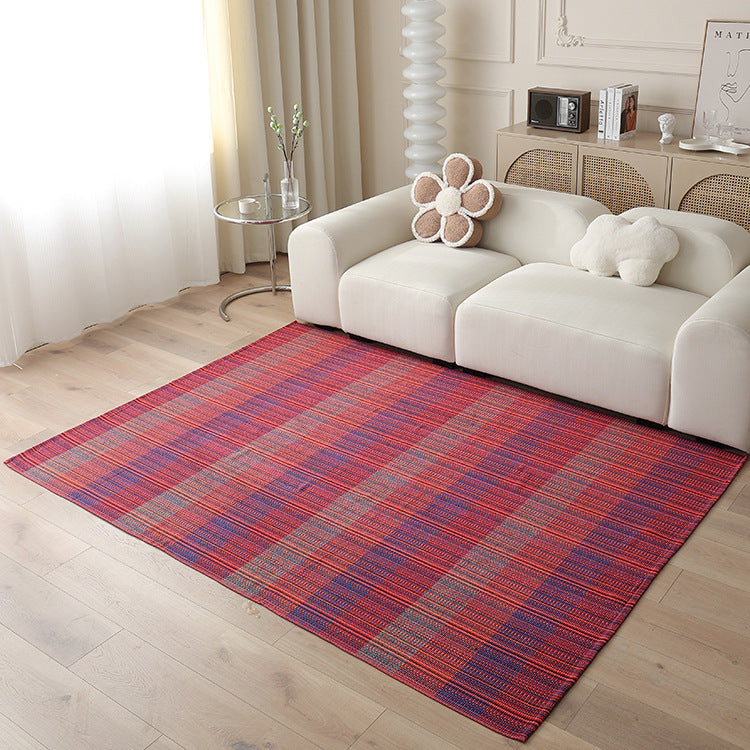 Woven living area rug with large check pattern and flat cotton texture