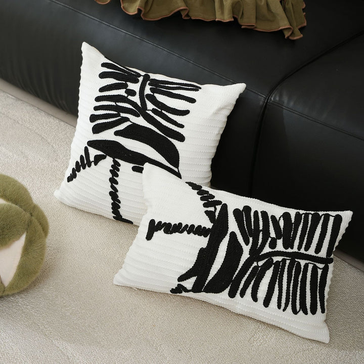 Decorative cushion cover with textured embroidery and geometric line motif