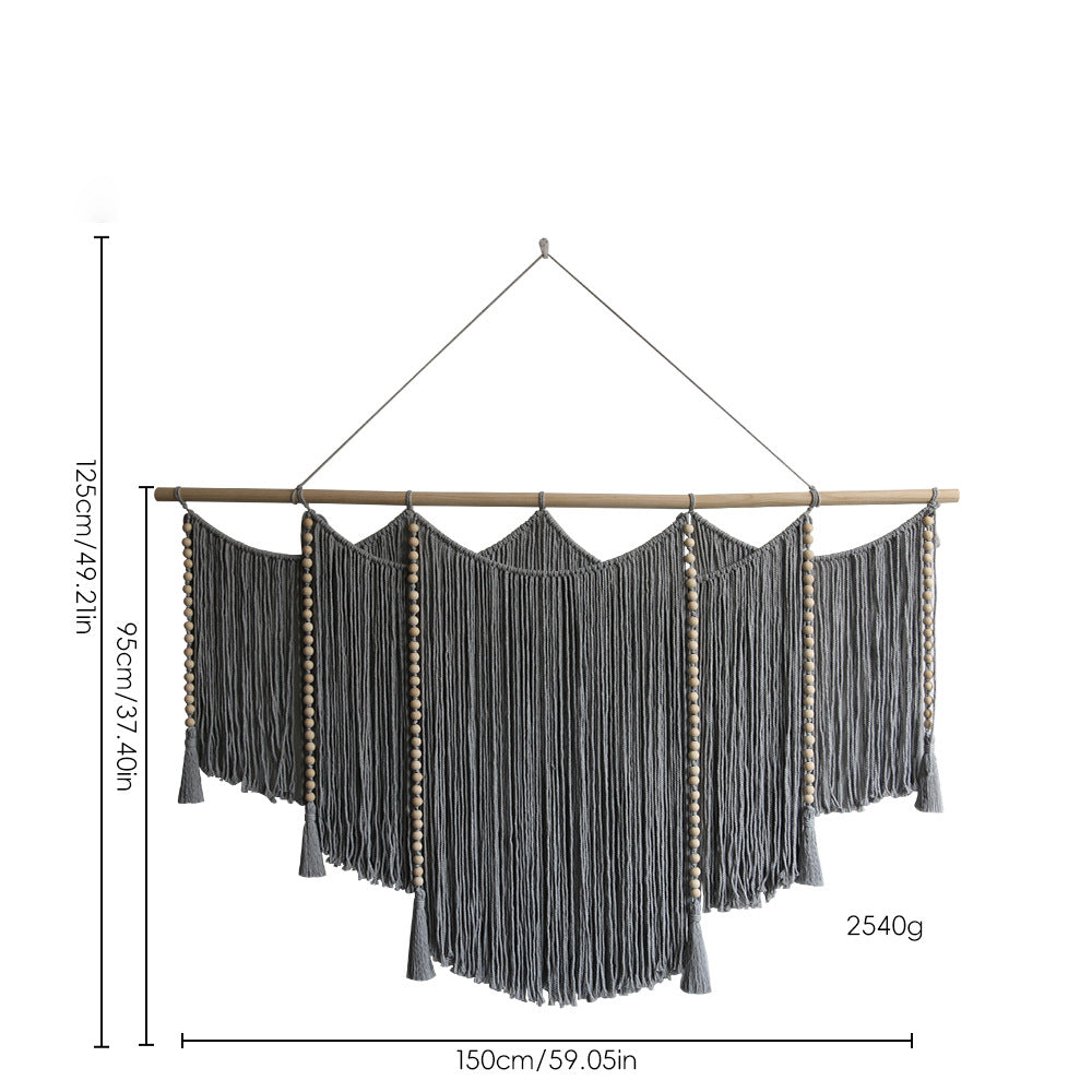 Macramé wall hanging with intricate fringes and wooden beads
