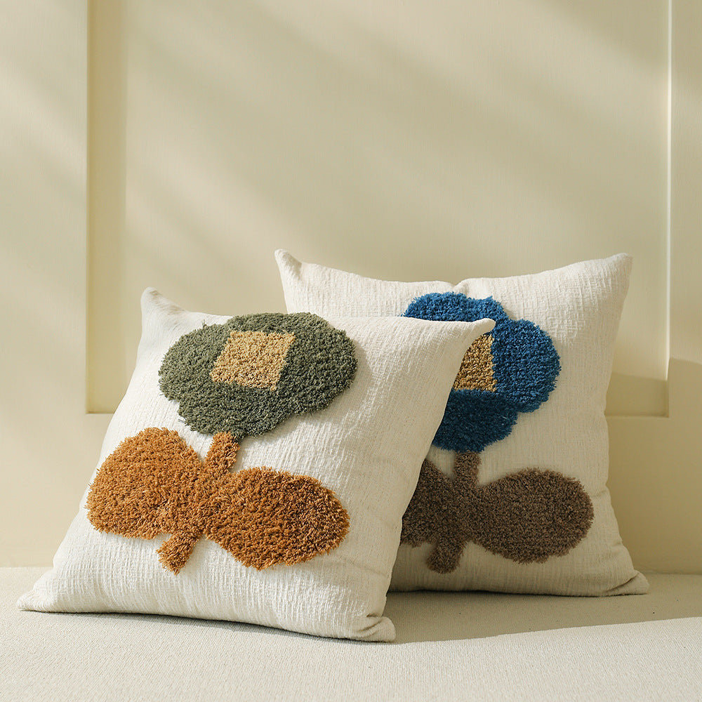 Decorative tufted cushion cover with hand-tufted flower applique