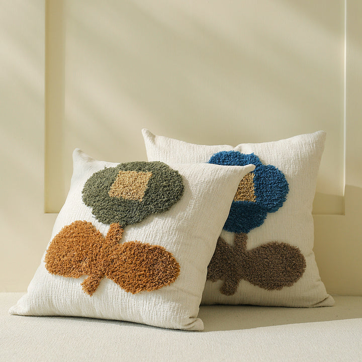 Decorative tufted cushion cover with hand-tufted flower applique