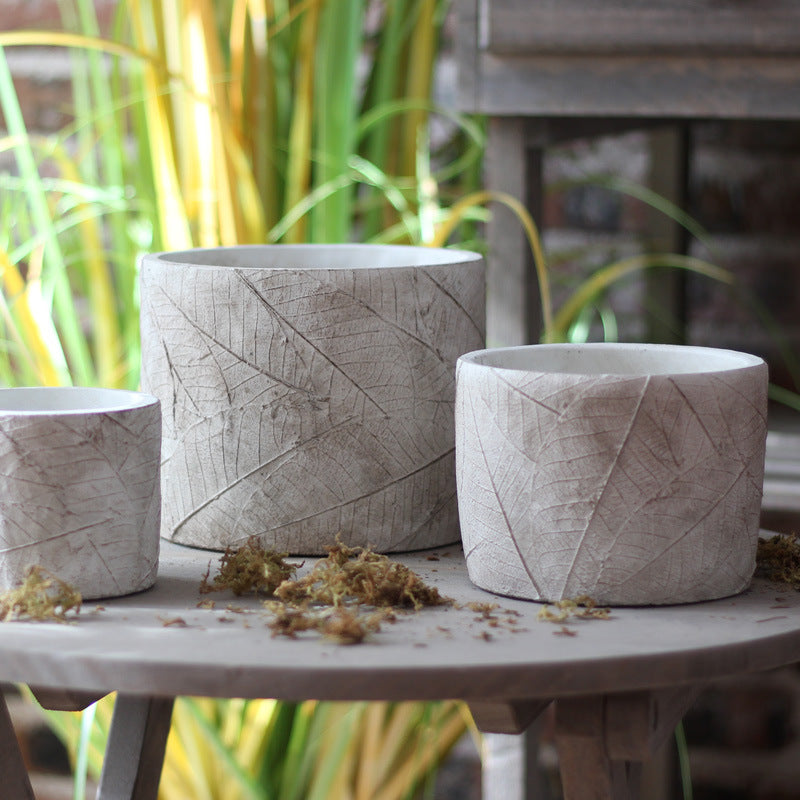 Decorative plant container made of handmade ceramic with leaf pattern