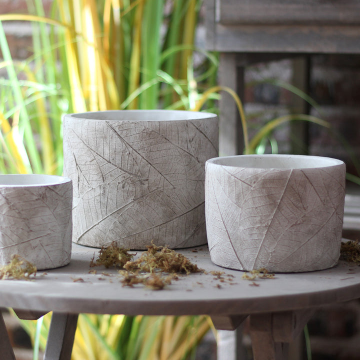 Decorative plant container made of handmade ceramic with leaf pattern
