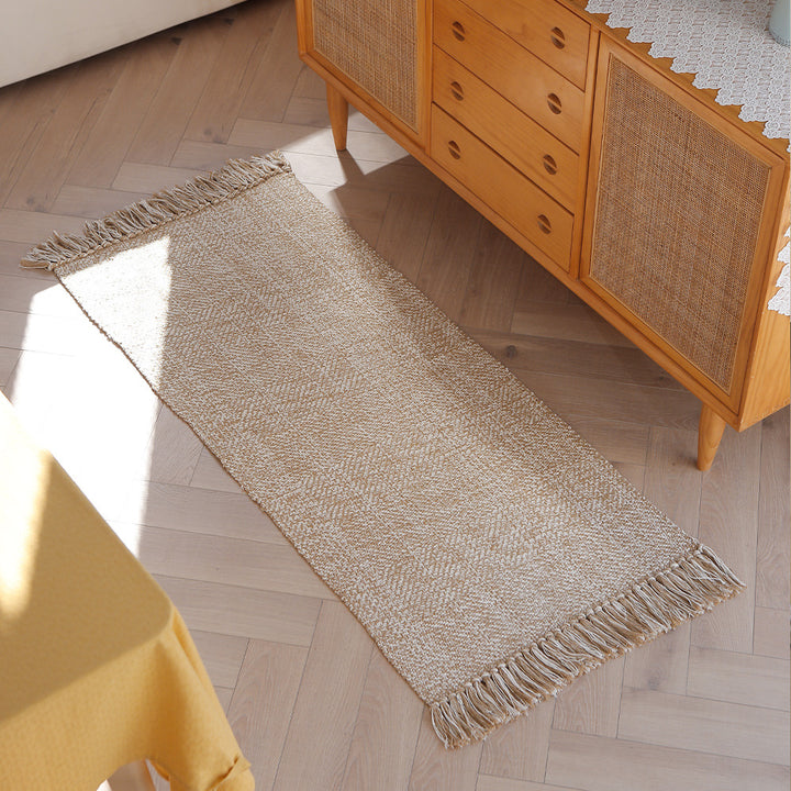 Woven table runner made of cotton blend with fine structure and herringbone look as well as decorative fringes