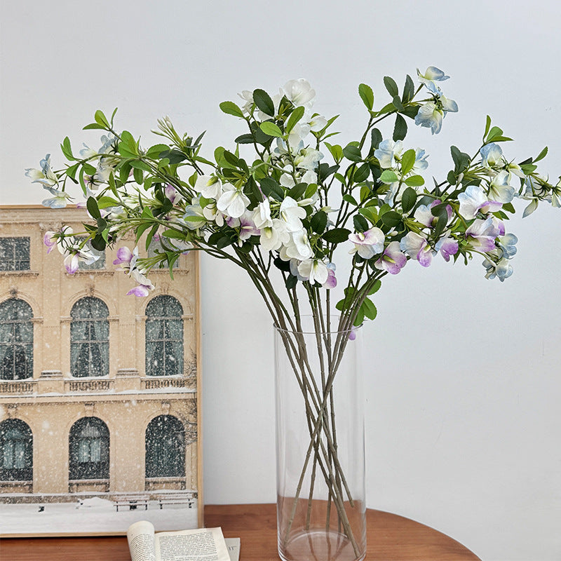 Artificial flower branch with vibrant pink flowers
