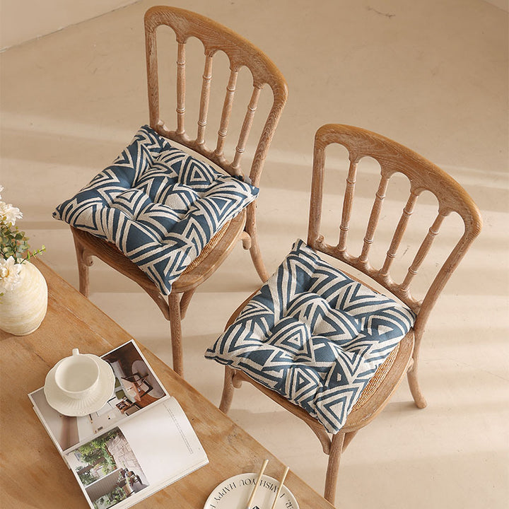 Padded quilted seat cushion with colorful button applications and non-slip underside