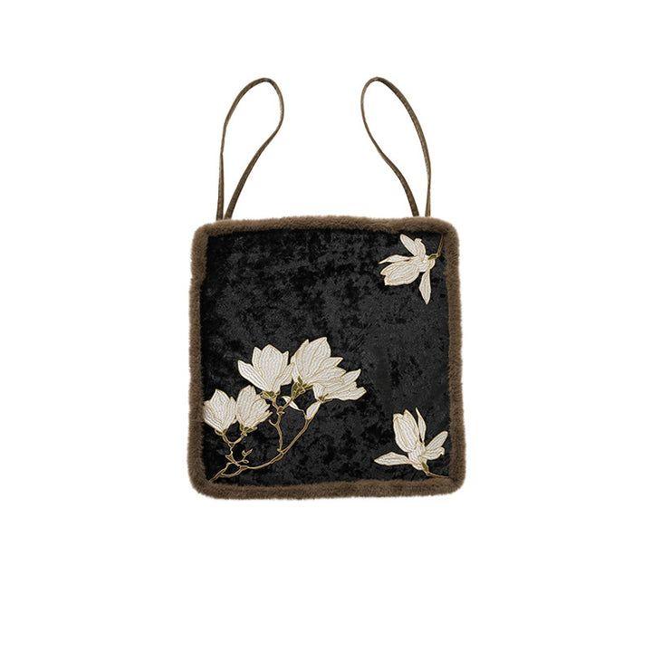 Padded seat cushion with velvet cover, floral embroidery and faux fur trim