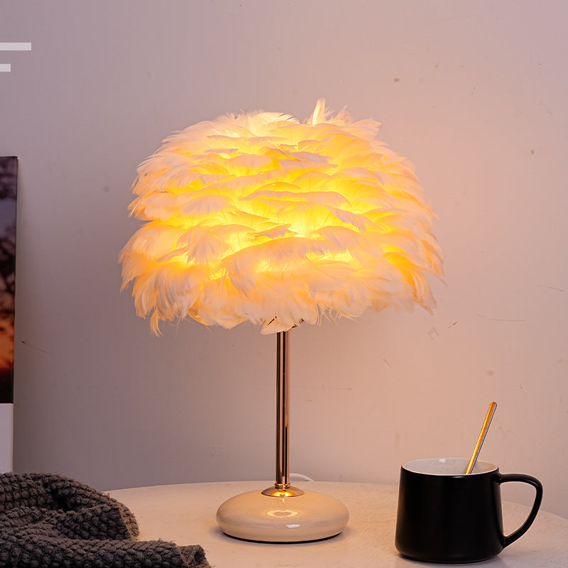 Feather shade table lamp with ceramic base and polished metal rod