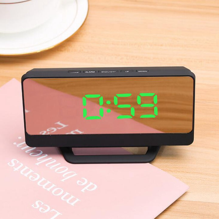 Digital alarm clock with mirror display and snooze function