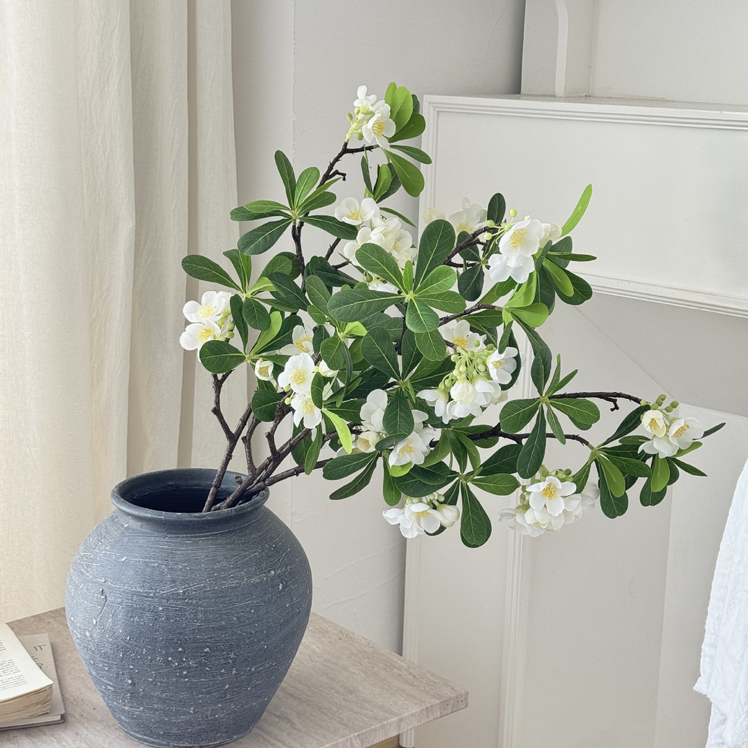 Artificial flower branch with fine pink flowers and vibrant leaves