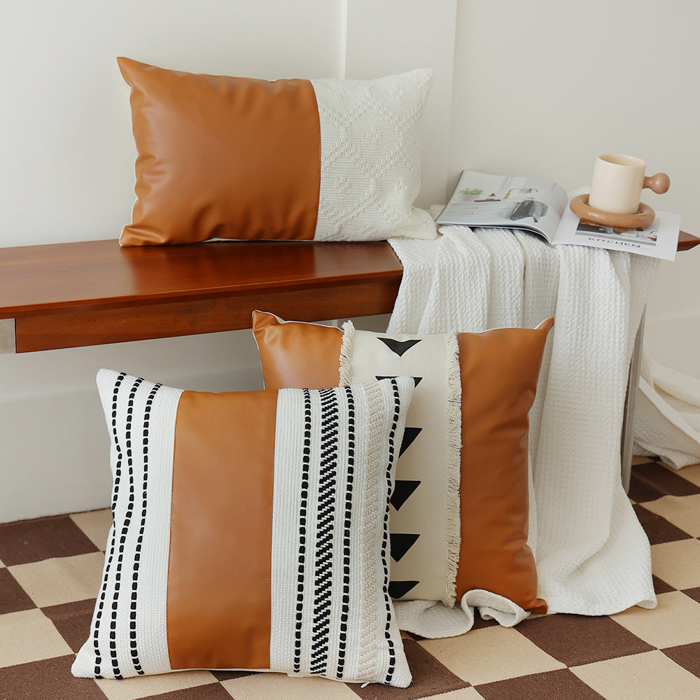Square faux leather decorative cushion with woven central stripe and fringes