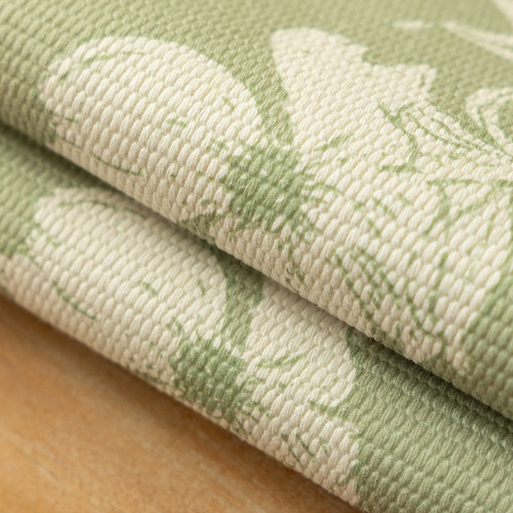 Woven table placemat made of cotton blend with olive branch print and decorative fringe edge