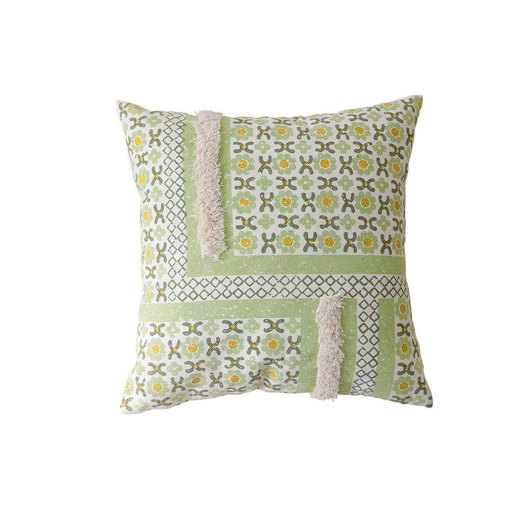 Woven decorative pillow with botanical jacquard pattern and pom-pom trim