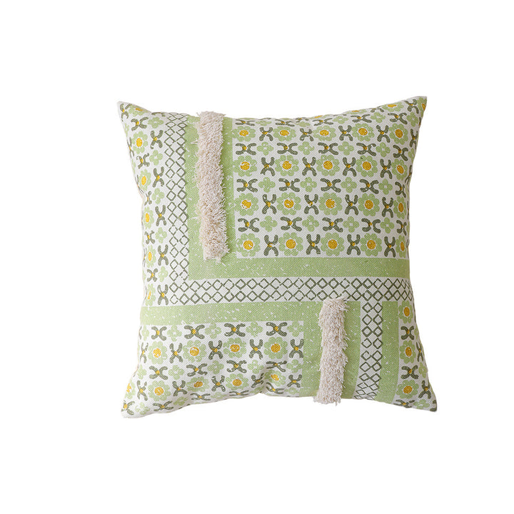 Woven decorative pillow with botanical jacquard pattern and pom-pom trim