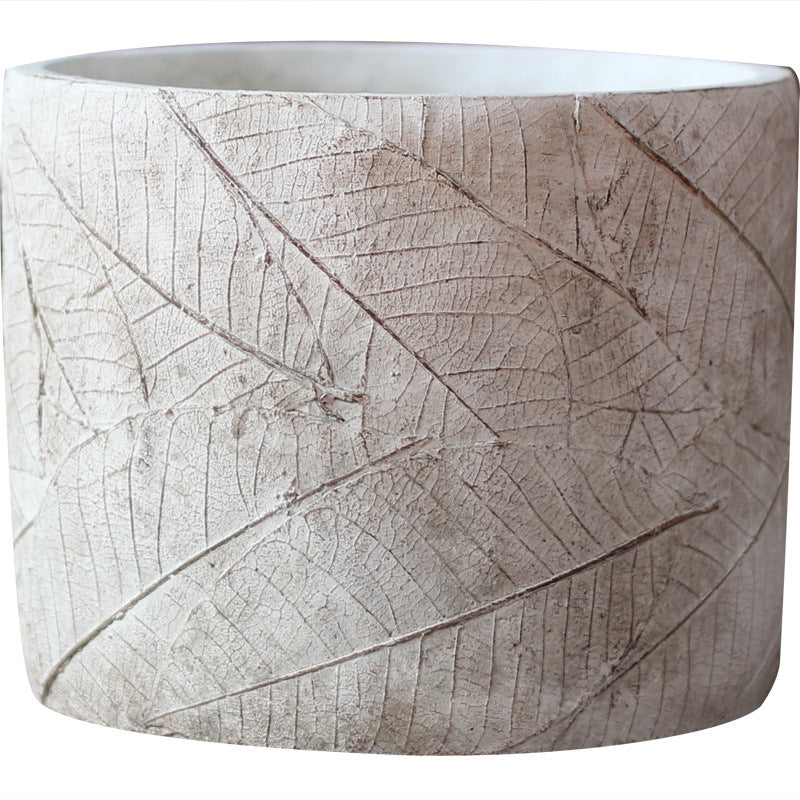 Decorative plant container made of handmade ceramic with leaf pattern