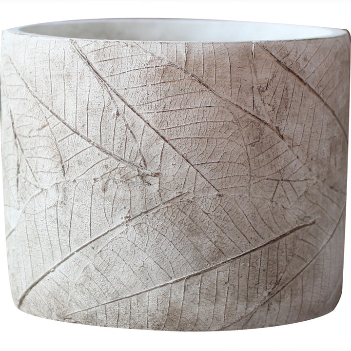 Decorative plant container made of handmade ceramic with leaf pattern