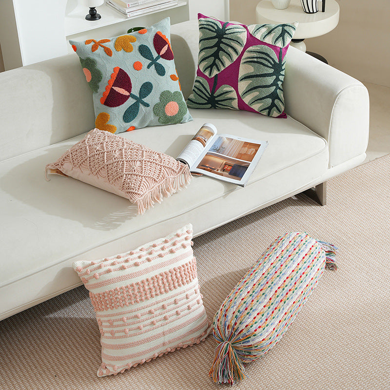 Woven decorative pillow cover with hand-tufted floral appliqués and bouclé relief
