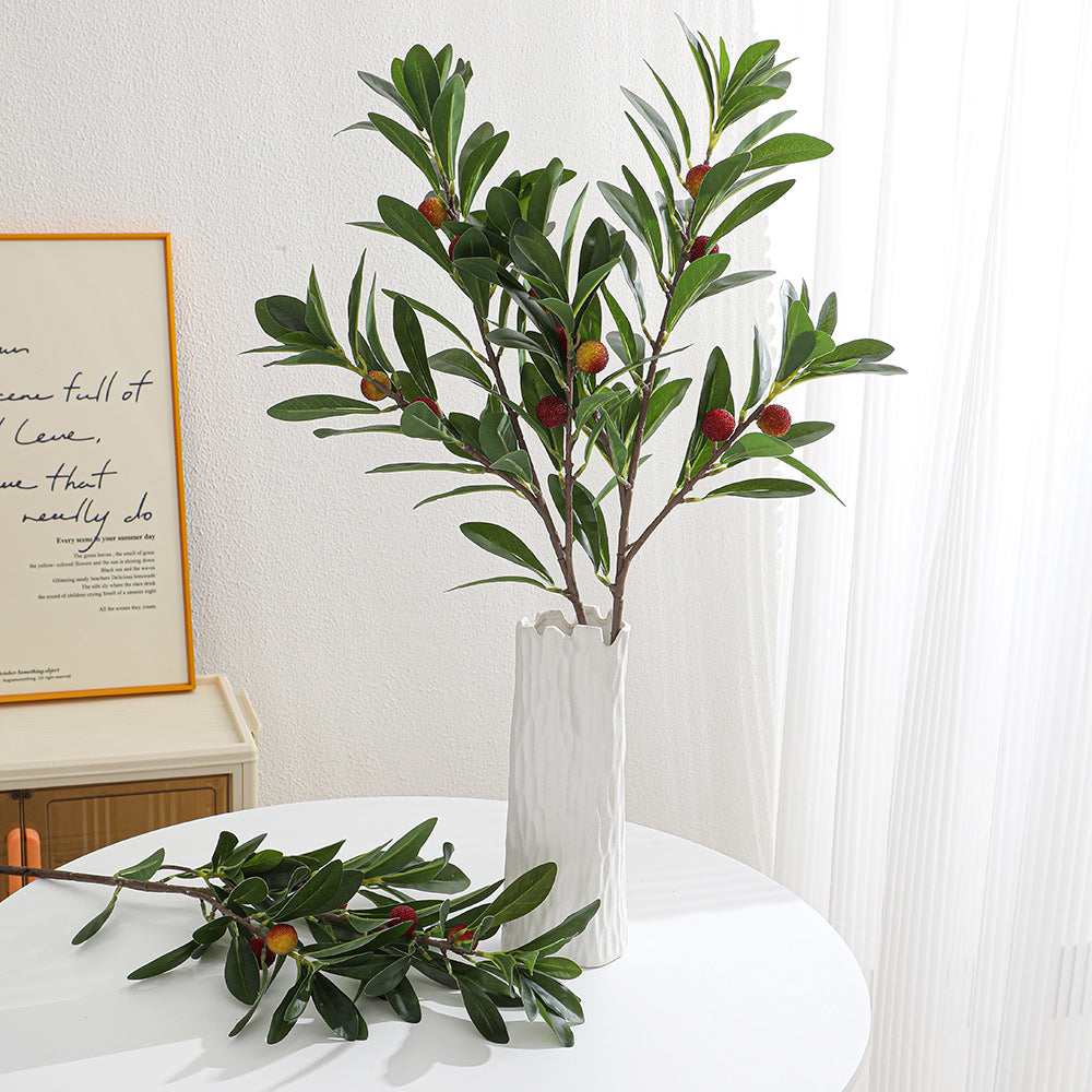 Artificial branch with decorative fruits