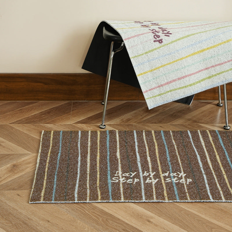 Woven door mat with welcome inscription, striped pattern and non-slip back