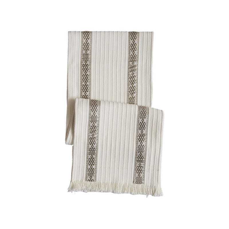 Woven table runner with contrasting center stripe, textured waffle look and decorative fringes