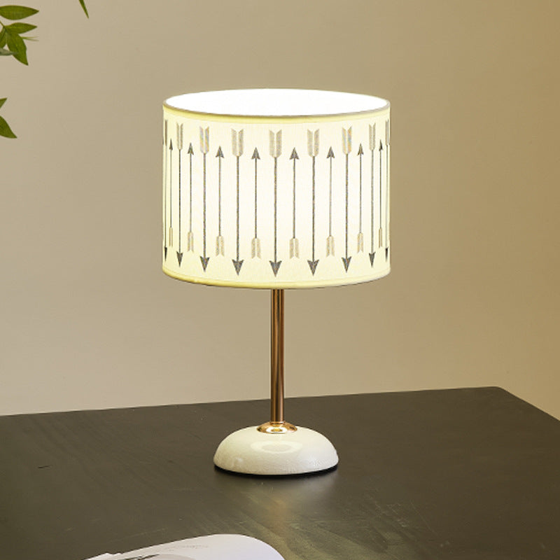 Ceramic base bedside lamp with fabric shade in arrow pattern