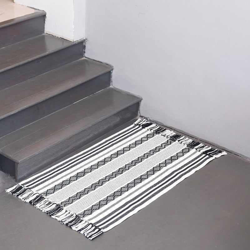 Flat-woven cotton runner with fringes and graphic ethnic stripe pattern